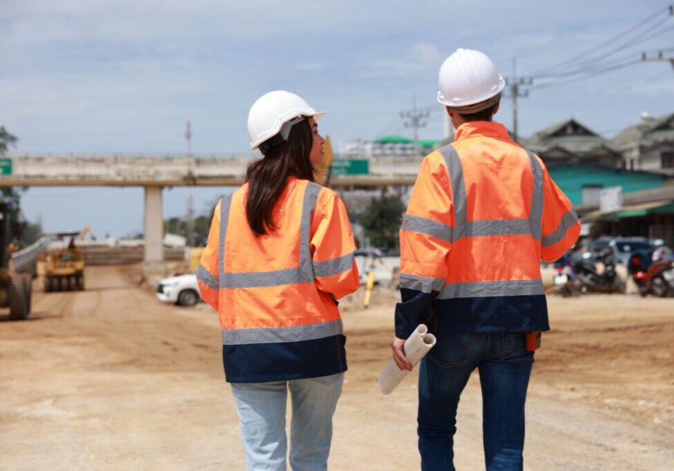 Two construction workers at a job site.